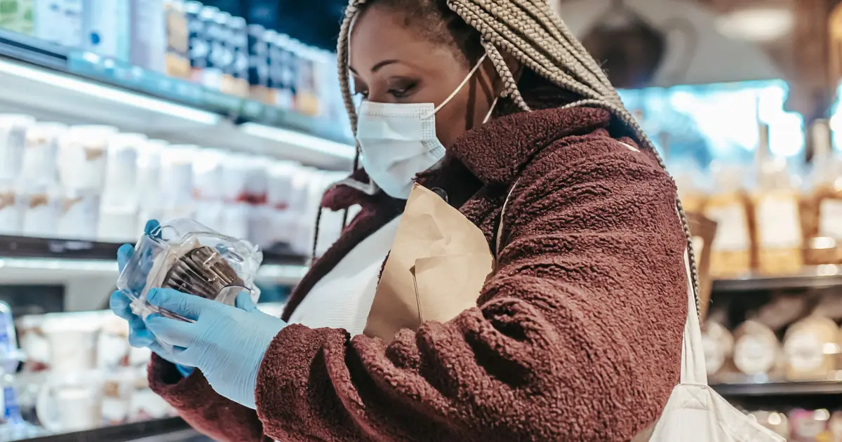 Cat owner checking a cat food label and lot number for a recall