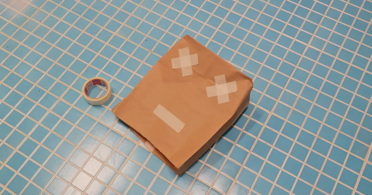 a taped square on the floor for a cat to sit in